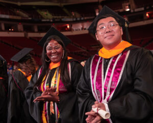 Graduates in academic regalia at Commencement