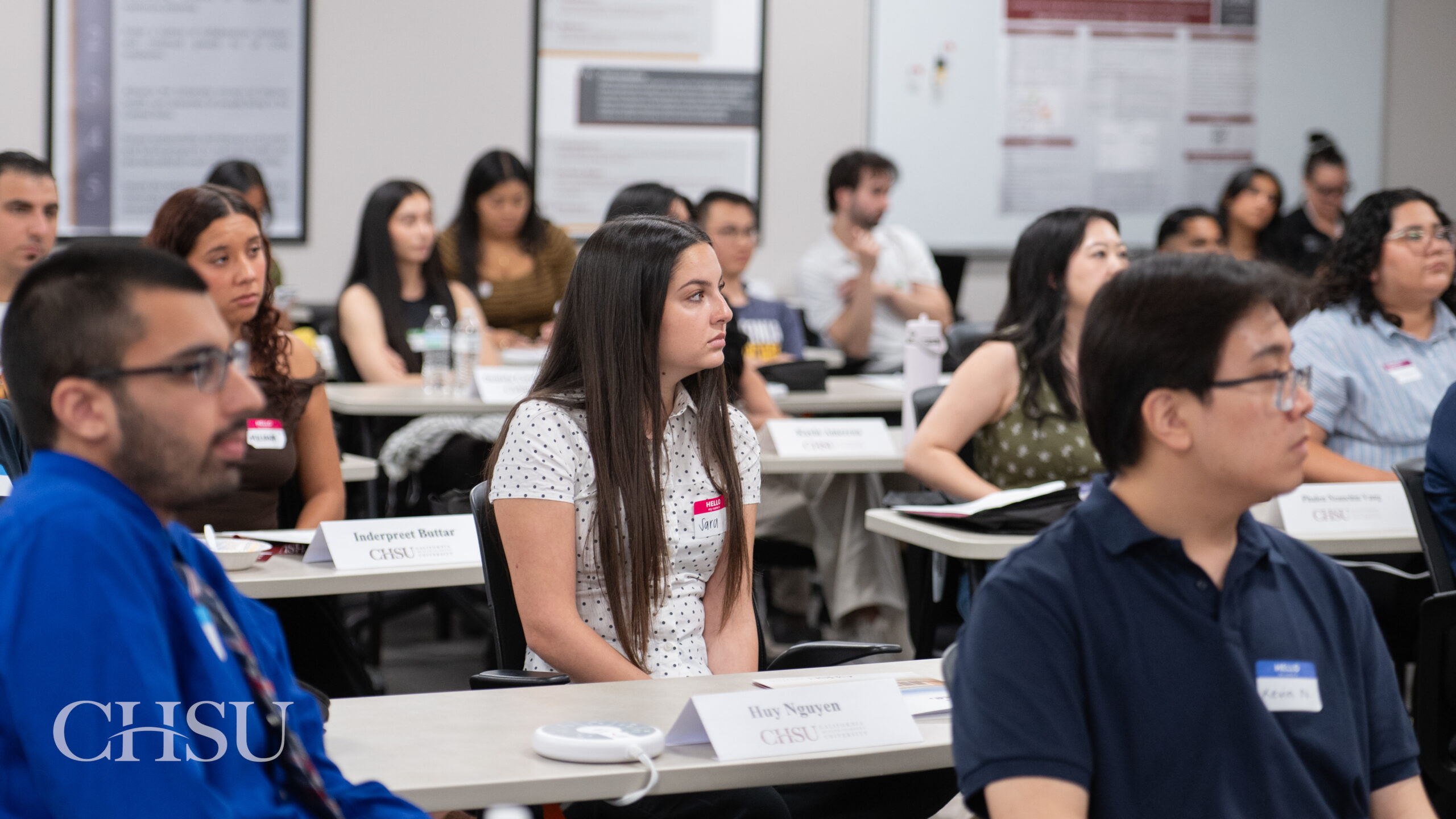 CHSU MSBS Class of 2027 students listen to a presentation in a classroom during orientation.