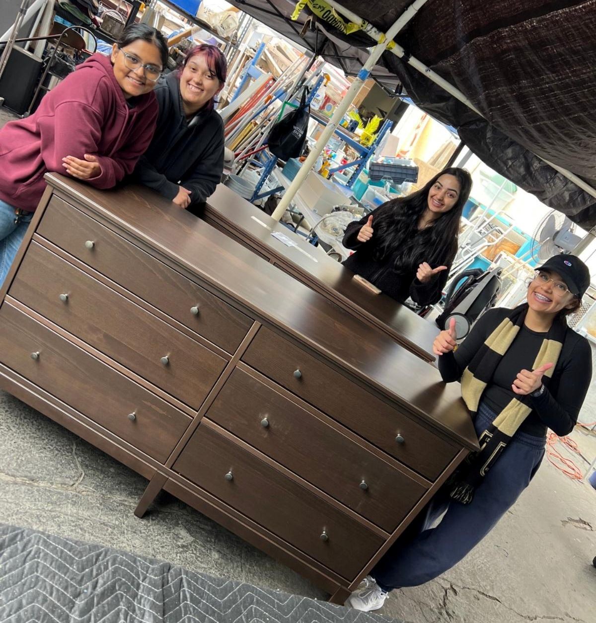 students standing behind dresser