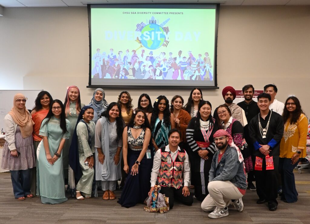 group photo of people wearing cultural attire in classroom