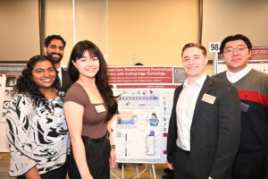 People standing in front of research poster