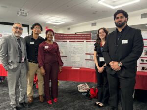 People standing in front of research poster