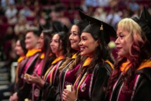 MSBS graduates wearing regalia standing at Commencement ceremony